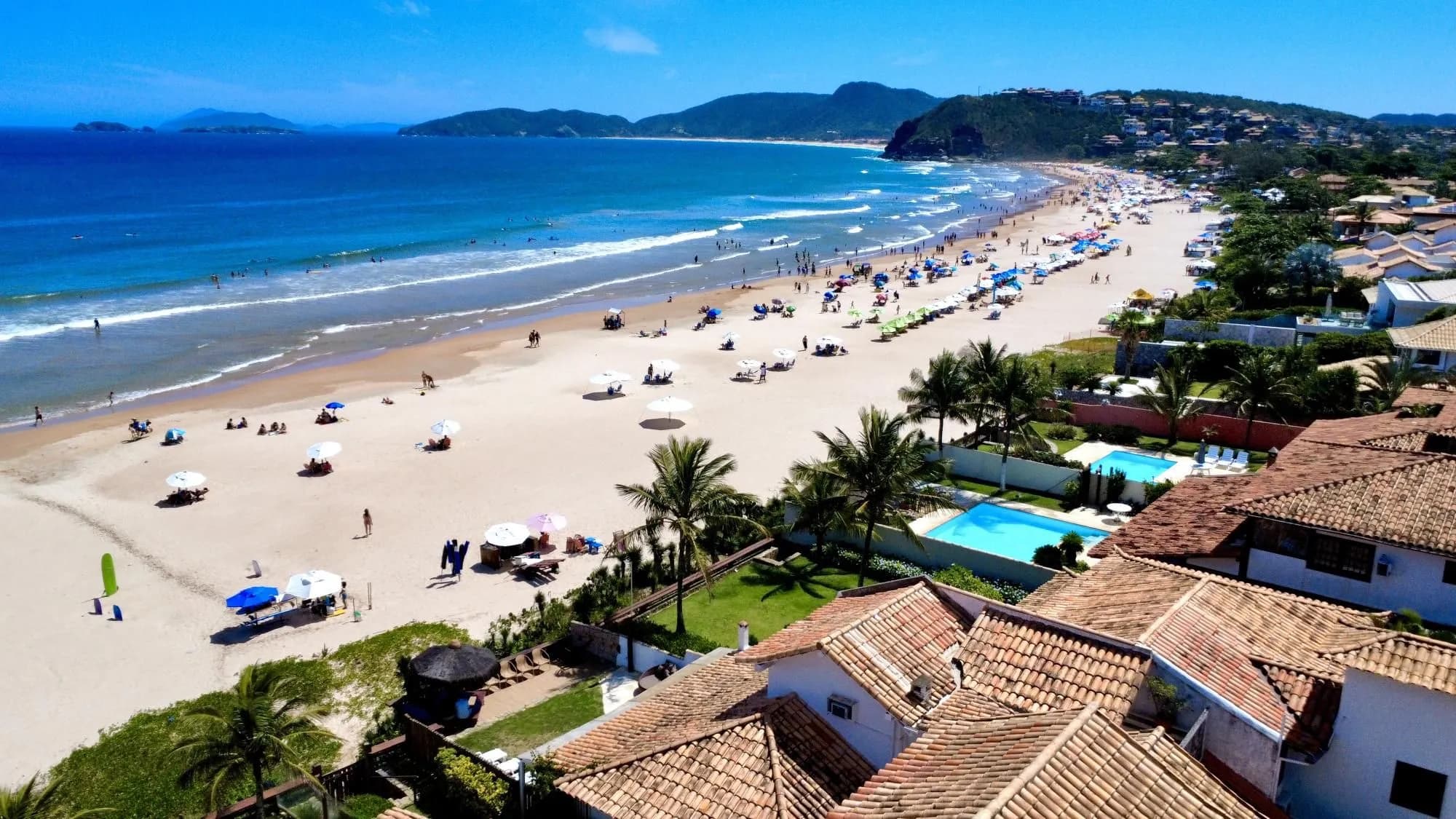 Vista aérea de casas com piscina à beira da praia em Búzios